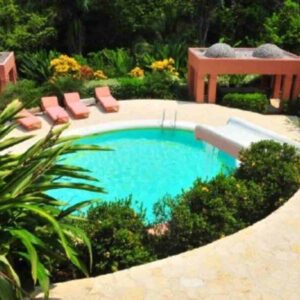 The luxurious villa with 4 bedrooms and 4 bathrooms was completely custom designed as the style of Colonial-Moorish. Exquisite interior design, unique materials and a well landscaped outdoor area make this house special. On the main level are three of the bedrooms with queen size beds, two of them with private bath. The master suite is on the upper level, has a king-size bed, a walk-in closet with hand-made cabinets as well as a private bath with a jacuzzi tub. The dining room is connected to the kitchen and can accommodate 8 people, if you wish to eat outside, there is another dining area that can fit the same amount of people or if you choose to connect both tables you can make space for 16 people. This private, tasteful house with it’s spacious outdoor area would be by all means the right location to invite friends and family over or to host a wedding and other events as well. In the living room there Is a large 42” flat screen TV with DVD and sound system to entertain you. The outdoor area includes a large veranda, 2 pools, one of them is 18 meters long and 3 meters wide and has the exceptional feature of a sunken bar and BBQ grill on one of the ends. Relaxing at the pool and being able to enjoy a cocktail and delicious food at the same time is an experience you should not miss. The other one is a smaller plunge pool surrounded by lounge chairs and palm trees.